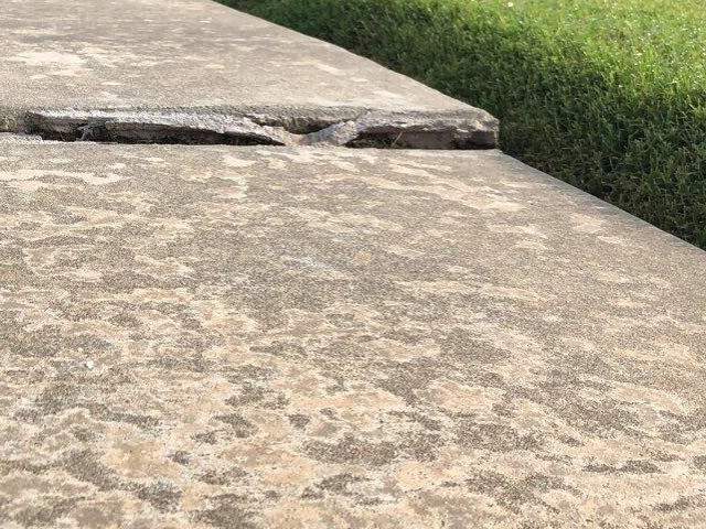 uneven concrete driveway surface needing replacement